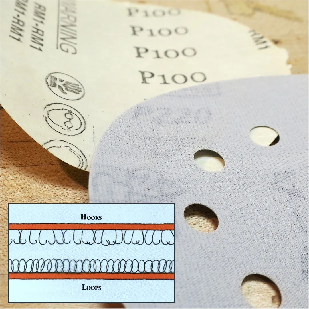  close up of the adhesive side of a 6 inch psa and hook and loop sanding pad